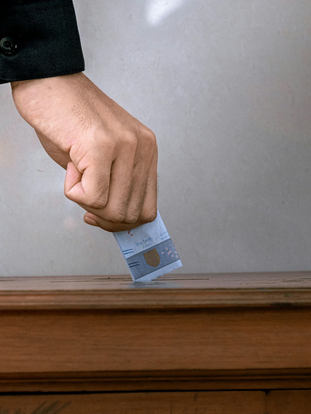 person-holding-white-and-blue-soft-tube-ugefxgjwwm0